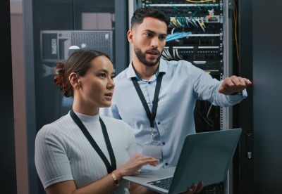 man and woman with a laptop explaining something